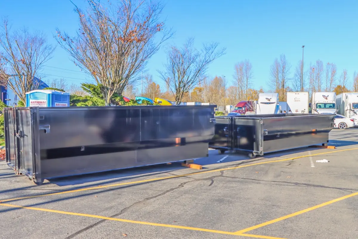 Professional dumpster rental service with roll-off container on residential driveway in Goose Creek